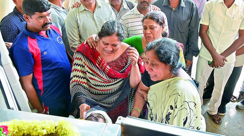 Relatives pay respects to M. Suresh Babu, reserve police inspector, who was killed in a road mishap on Tuesday. (Photo: DC)