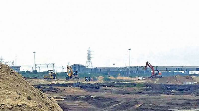 The bunds being constructed along the west side of the Ennore creek .