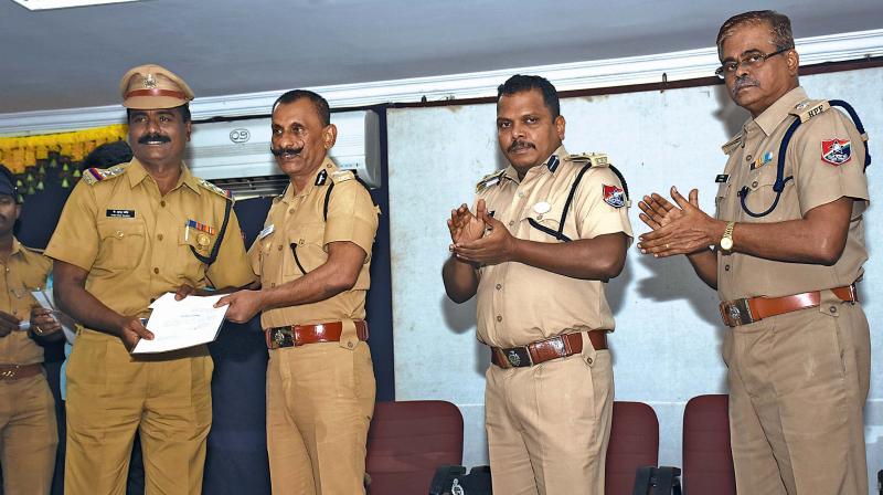 Inspector General of Railway Police Force and idol wing Pon Manickavel on the eve of his retirement on Thursday  hands over the certificates to the Railway Protection Force personnel at ICF, Ayanavaram. (Photo: DC)