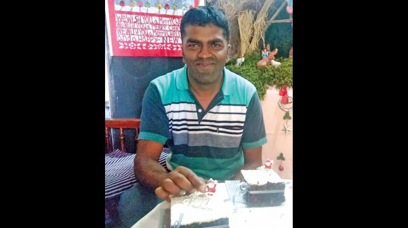 B.Wilfred Rozario, with the home made rich plum Xmas cake. (Photo: DC)