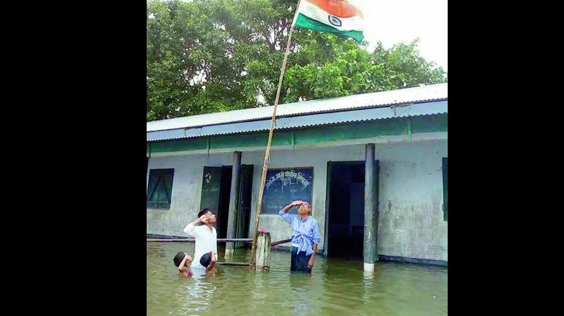 (left) Teachers and students of a school in flood-hit Dhubri district of Western Assam made sure the Tricolour was hoisted and the National Anthem was sung to celebrate Indias 71st Independence Day.