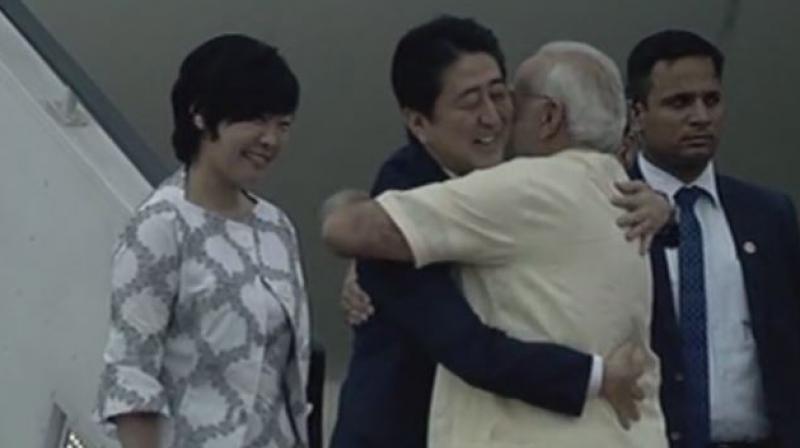Modi receives Japanese Prime Minister Shinzo Abe and his wife Akie Abe at Ahmedabad Airport. (Photo: ANI | Twitter)