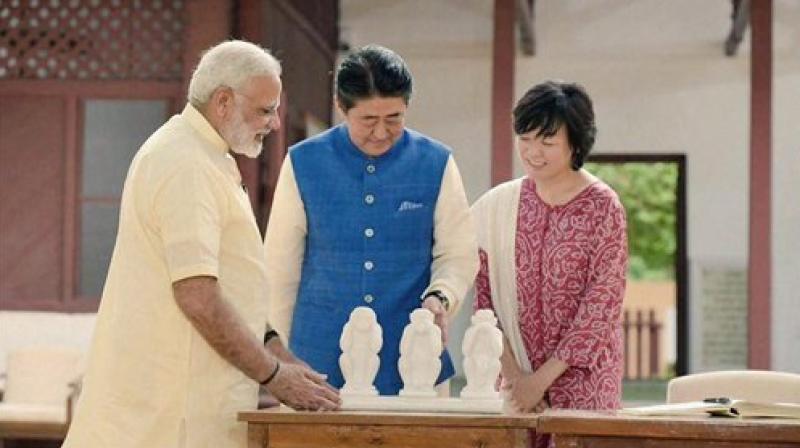 Prime Minister Narendra Modi explains to Japanese Prime Minister Shinzo Abe and his wife Akie about the concept of the three wise monkeys of Mahatma Gandhi, at Gandhi Ashram in Ahmedabad on Wednesday. (Photo: PTI)