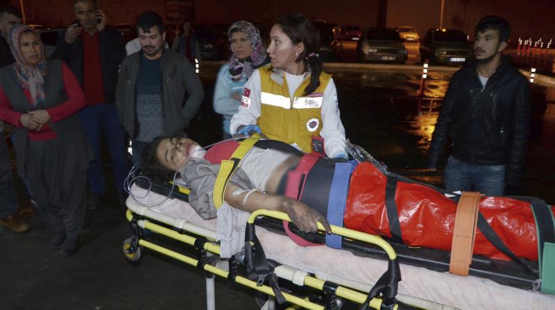 Medics carry a wounded student to an ambulance in Aladag, Adana in southern Turkey late on Tuesday. (Photo: AP)