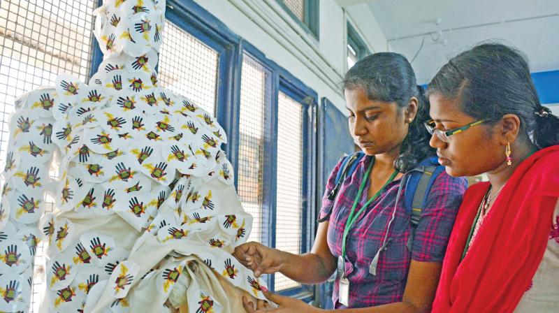Girls at Womens Christian College using stickers to mark on the mannequin, the harassment faced by them on streets. )Photo: DC)