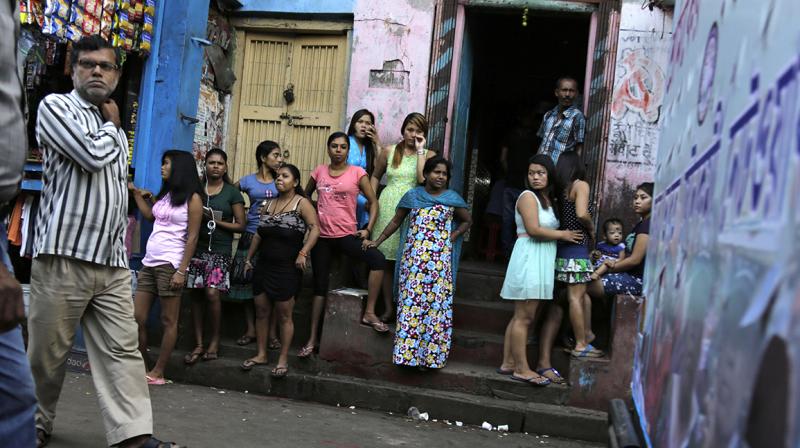 Girls stand outside the Kolkatas biggest red-light zone, Sonagachhi. (Photo: AP)
