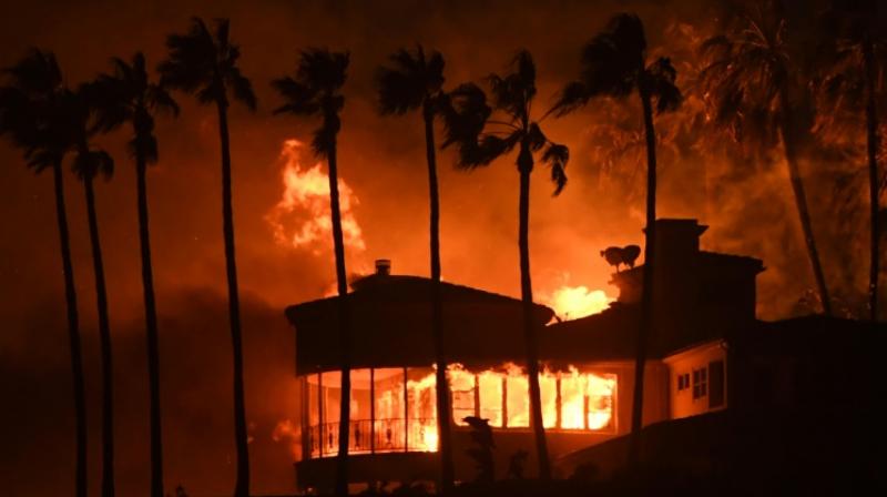 A house burns in the Hollywood resort town of Malibu -- about 88,000 homes have been evacuated in Los Angeles and Ventura counties. (Photo: AFP)