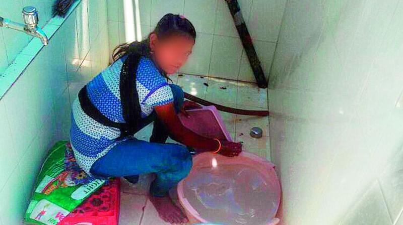 The girl washes plates at the Rachakonda police HQ canteen in Gachibowli. (Photo: DC)