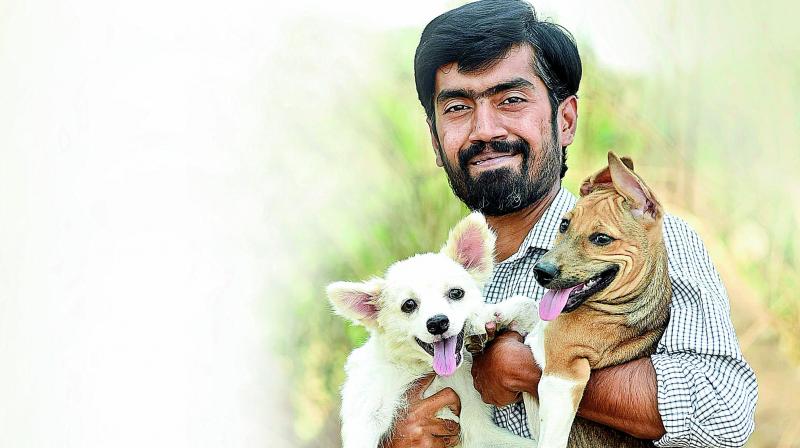 Pradeep with his paralysed pomeranian Bablu and injured dog Gigi
