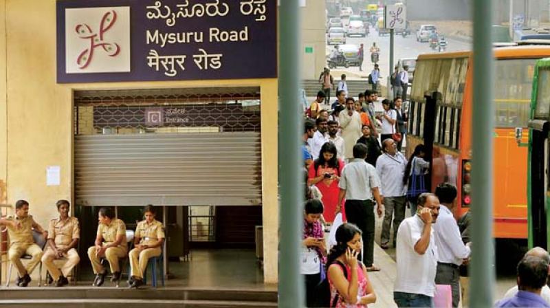 Many office-goers hit by disruption of train services, striking workers block Old Madras Road.