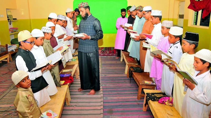 Students of a madrasa offer prayers in the Old City on Saturday. 	(Photo: DC)