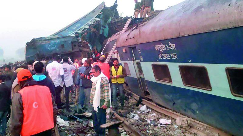 Rescue workers search for survivors in the wreckage of the Indore-Patna Express that derailed near Pukhrayan in Kanpur district on Sunday. Emergency workers raced to help more survivors in the mangled wreckage. (Photo: AFP)