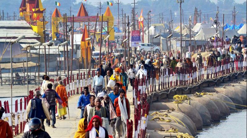 Pilgrims arrive to take holy dip in river Ganges on the eve of Makar Sankranti festival during the annual Magh Mela in Allahabad. (Photo)