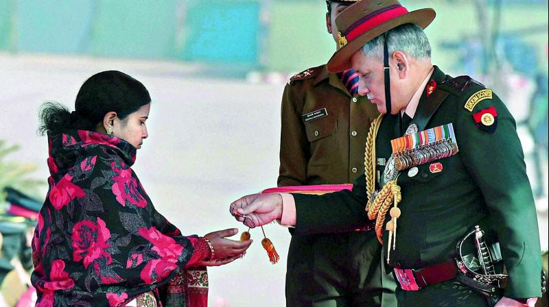 Army Chief Gen. Bipin Rawat honours Siachen braveheart Lance Naik Hanamanthappa Koppads widow during the Army Day parade in New Delhi on Sunday.  (Photo: PTI)