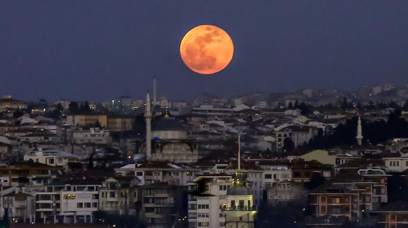A picture taken on January 31, 2018 shows the moon during a lunar eclipse, referred to as the \super blue blood moon\ up in the sky above the Bosphorus straits in Istanbul. (Photo: AFP)