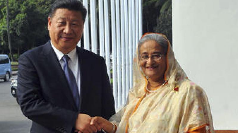 Bangladesh Prime Minister Sheikh Hasina shakes hands with Chinese President Xi Jinping in Dhaka, Bangladesh. (Photo: AP)
