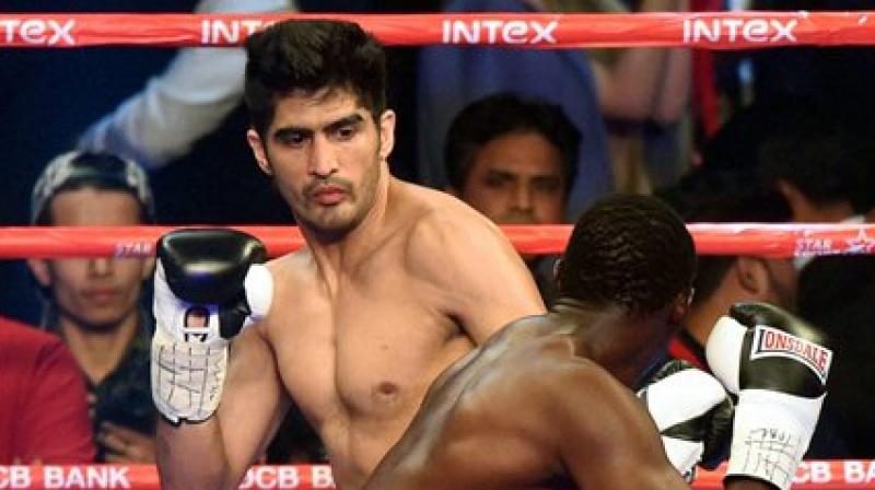 Indian boxing star Vijender Singh fights with Francis Cheka of Tanzania during the Proboxing match in New Delhi on Saturday. (Photo: PTI)