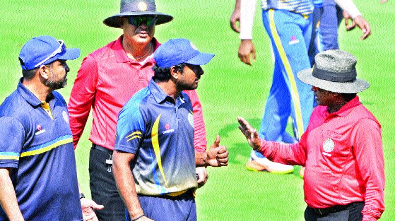 Hyderabad captain A. T. Rayudu (centre) argues with the umpire over a controversial decision after their loss to Karnataka in Vizag on Thursday.	(Photo: P. N. Murthy)