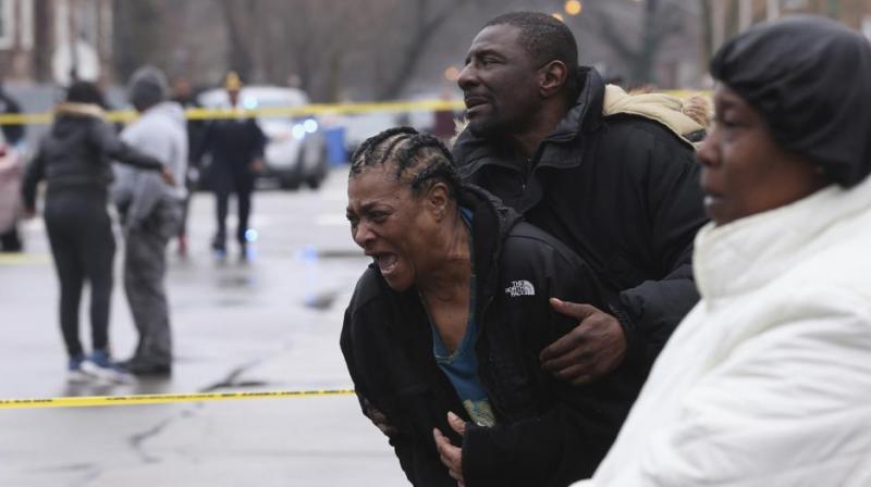 Georgia Jackson, 72, is overcome with emotion upon learning that her two grandsons, Raheem and Dillon Jackson were found fatally shot in the South Shore neighborhood in Chicago (AP Photo)