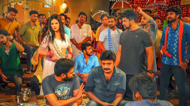 Working still from the sets of Garuda Vega 126.18M. Seen are Rajasekhar, Sunny Leone and Praveen Sattaru