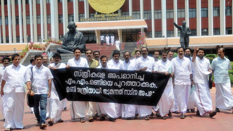 Opposition members take out a march after walking out of the assembly on Tuesday, seeking the ouster of power minister M.M. Mani from the post. 	(Photo: A.V. MUZAFAR)