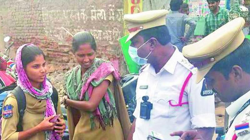 Traffic police stop police personnel who were riding a motor bike without helmet.