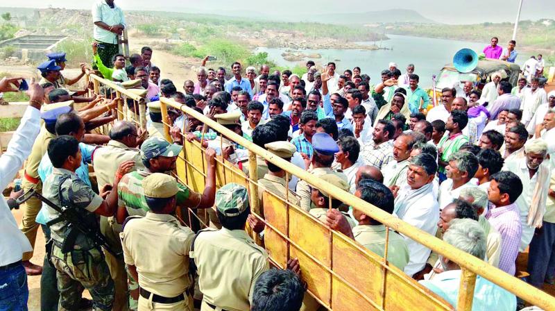 Police personnel stop farmers from Nalgonda district trying to barge into the Pulichintala project on Saturday. (Photo: DC)