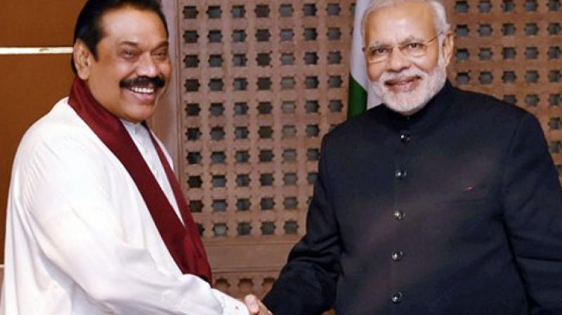 Sri Lankas former President Mahinda Rajapaksa with Narendra Modi. (Photo: PTI)
