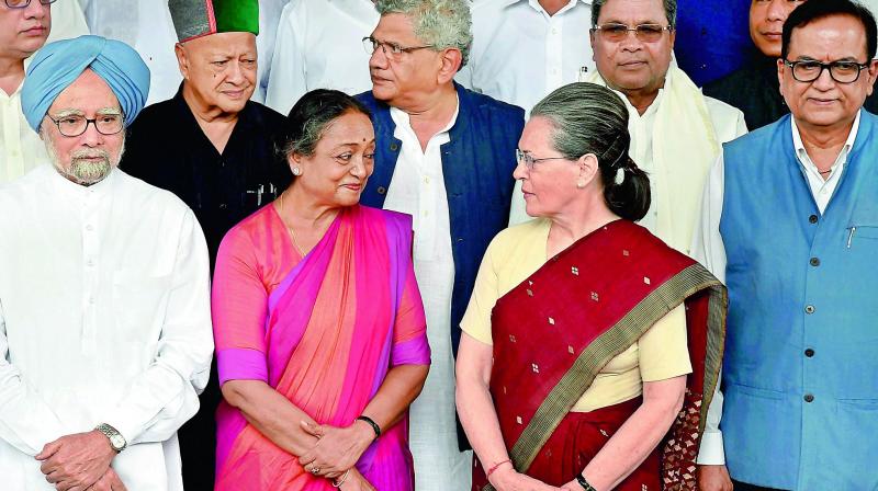 Opposition presidential candidate Meira Kumar with Congress chief Sonia Gandhi and former PM Manmohan Singh in New Delhi on Wednesday. (Photo: PTI)