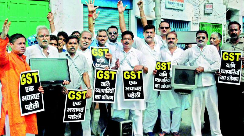 Traders protesting the Goods and Services Tax on electronic items, in Varanasi on Friday. Traders in Kanpur also sat in protest on rail tracks stopping the movement of trains. (Photo: PTI)