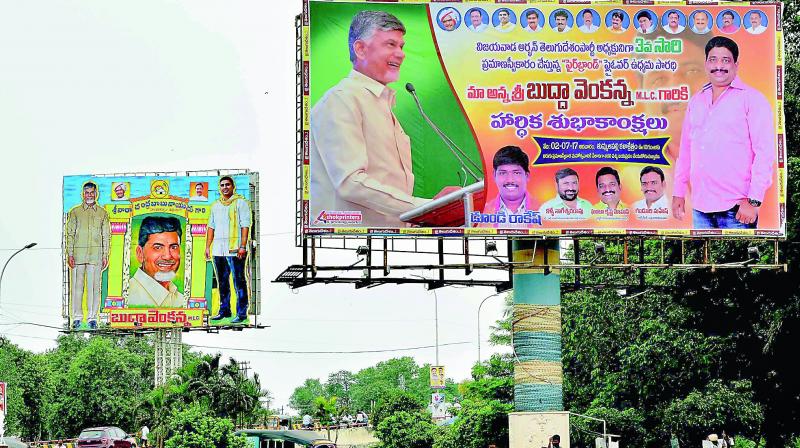 Followers of MLC Buddha Venkanna install flexis congratulating him on assuming charge as TD urban president for the third time in Vijayawada on Saturday. (Photo:  DC)