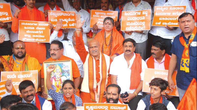Sri Rama Sene president Pramod Muthalik and members of various Hindu organisations stage a protest against a recent Iftar party, organised by Viswesha Tirtha Swamiji of Pejawar Mutt, in Bengaluru on Sunday.