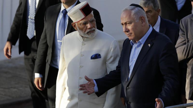 Indian Prime Minister Narendra Modi, left, accompanied by Israeli Prime Minister Benjamin Netanyahu, visits the Yad Vashem Holocaust memorial museum in Jerusalem. (Photo: AP)