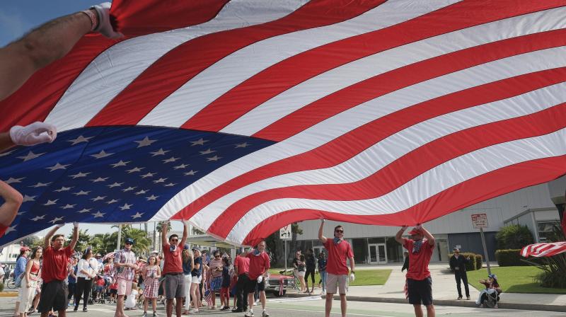 Participants carry an American flag during the 4th of July parade in Santa Monica. (Photo: AP)