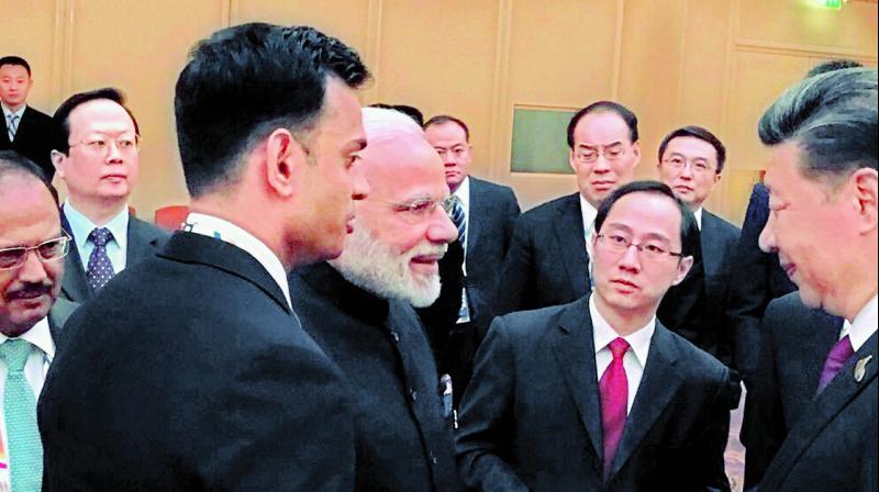Prime Minister Narendra Modi and Chinese President Xi Jinping exchange greetings in Hamburg on Friday. (Photo: PTI)