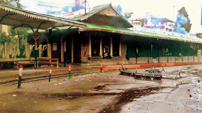 The torched a toy train station (left); and troops patrol a street in Darjeeling  on Saturday. (Photo: PTI)