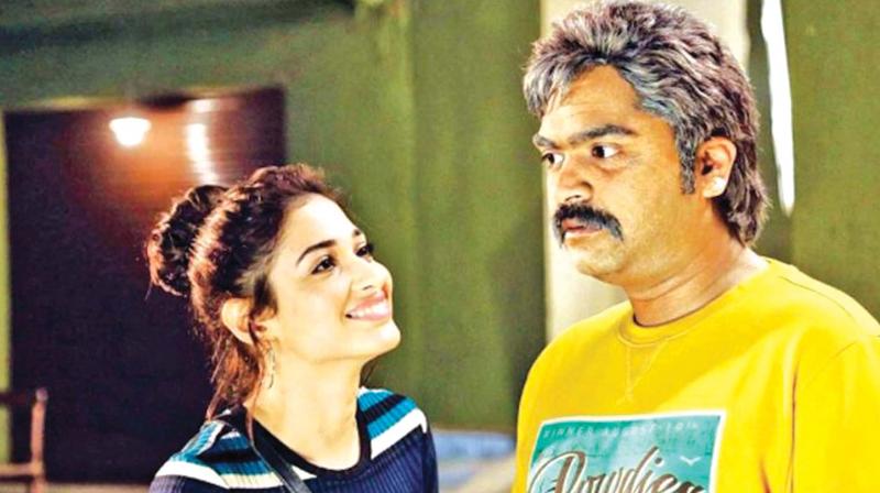 AAA featured STR in the roles of Madurai Michael and Ashwin Thatha .