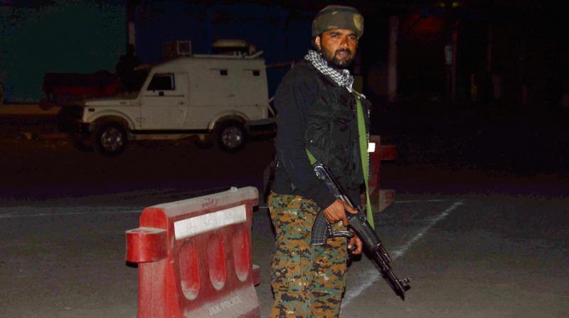 Security person stand guard after militants opened fire on the Amarnath Yatra in which some pilgrims were killed many injured in Anantnag in Jammu and Kashmir on Monday. (Photo: PTI)