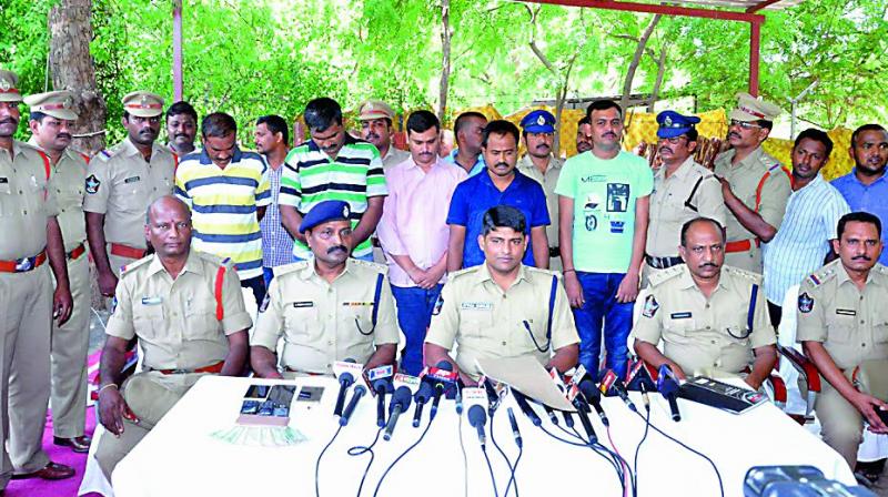 Kadapa SP Babuji produces the smugglers before mediapersons on Monday. (Photo: DC)