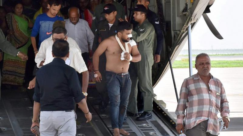 Amarnath pilgrims who were injured in Mondays terror attack at Anantnag in J & K, being brought by an IAF plane, at the airport in Surat on Tuesday. (Photo: PTI)