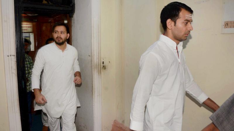 Bihar Deputy Chief Minister Tejaswi Yadav (L) with Health Minister Tej Partap Yadav arriving for the cabinet meeting at the secretariat in Patna. (Photo: PTI)