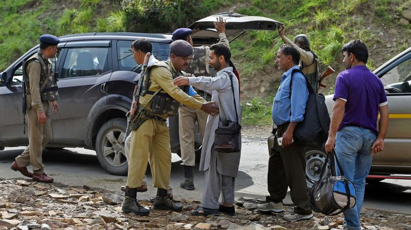 Security personnel frisking the yatris and the locals before they head towards the holy cave shrine following the militant attack on a bus in which seven pilgrims were killed and 19 others injured, at Nuwun base Camp in South Kashmir on Tuesday. (Photo: PTI)