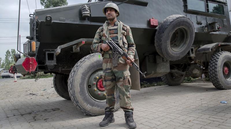An Indian army soldier stands guard at site of shootout in Batengoo about 50 Kilometres (31.25 miles) south Srinagar, Indian controlled Kashmir. (Photo: AP)