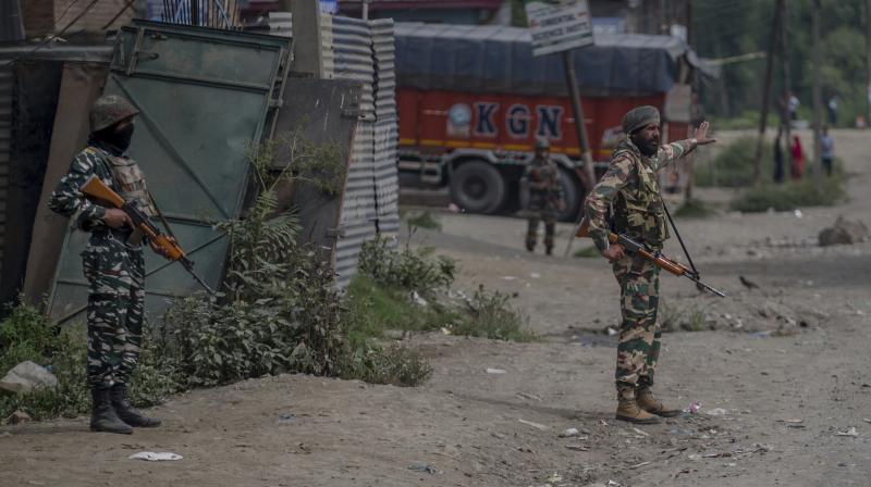 Indian army soldiers stand guard at the site of shootout in Batengoo about 50 Kilometres (31.25 miles) south Srinagar, Indian controlled Kashmir. (Photo: AP)