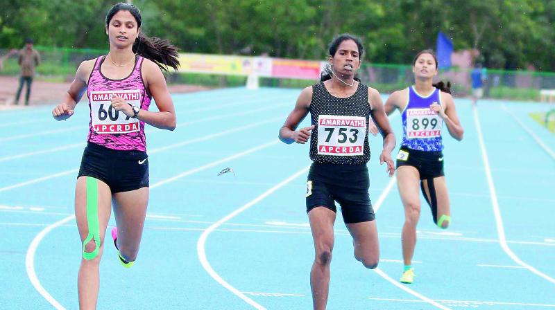 Women athletes from various states take part in the 400 metres hurdle at the Amaravati 57th National Inter-State Senior Athletics Championship-2017 at Acharaya Nagarjuna University on Saturday. (Photo: DC)
