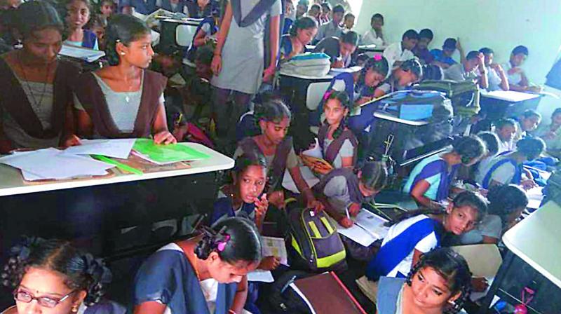 Huge numbers of schoolchildren sit in one classroom as the other classrooms of their school are damaged due to incessant rainfall at Zilla Parishad School near Makkuva in Vizianagarm district on Tuesday. (Photo: DC)