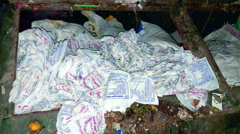 Empty packets of Pulihora prasadam in a dustbin atop Indrakeeladri in Vijayawada on Monday. (Photo DC)