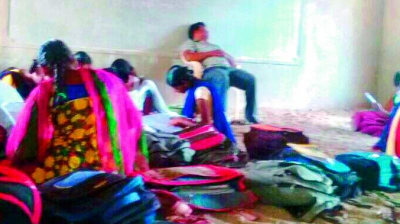 A WhatsApp image of maths teacher, K. Ramaulu S.A., sleeping in school during working hours. (Photo: DC)