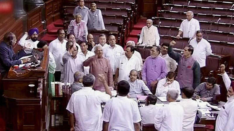 Opposition members protesting in the Well of Rajya Sabha in the Parliament, New Delhi on Monday. (Photo: PTI)