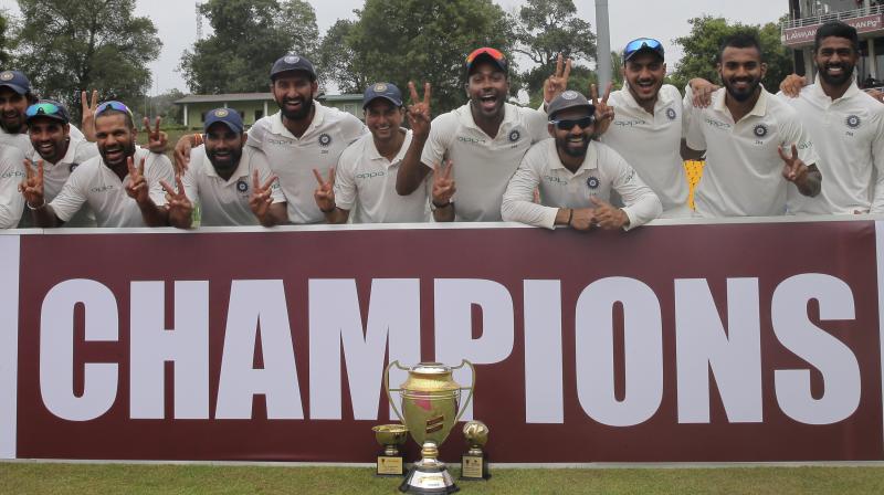 Members of Indian cricket team pose with the winners trophy after their win over Sri Lanka in the third cricket test match in Pallekele. (Photo: AP)